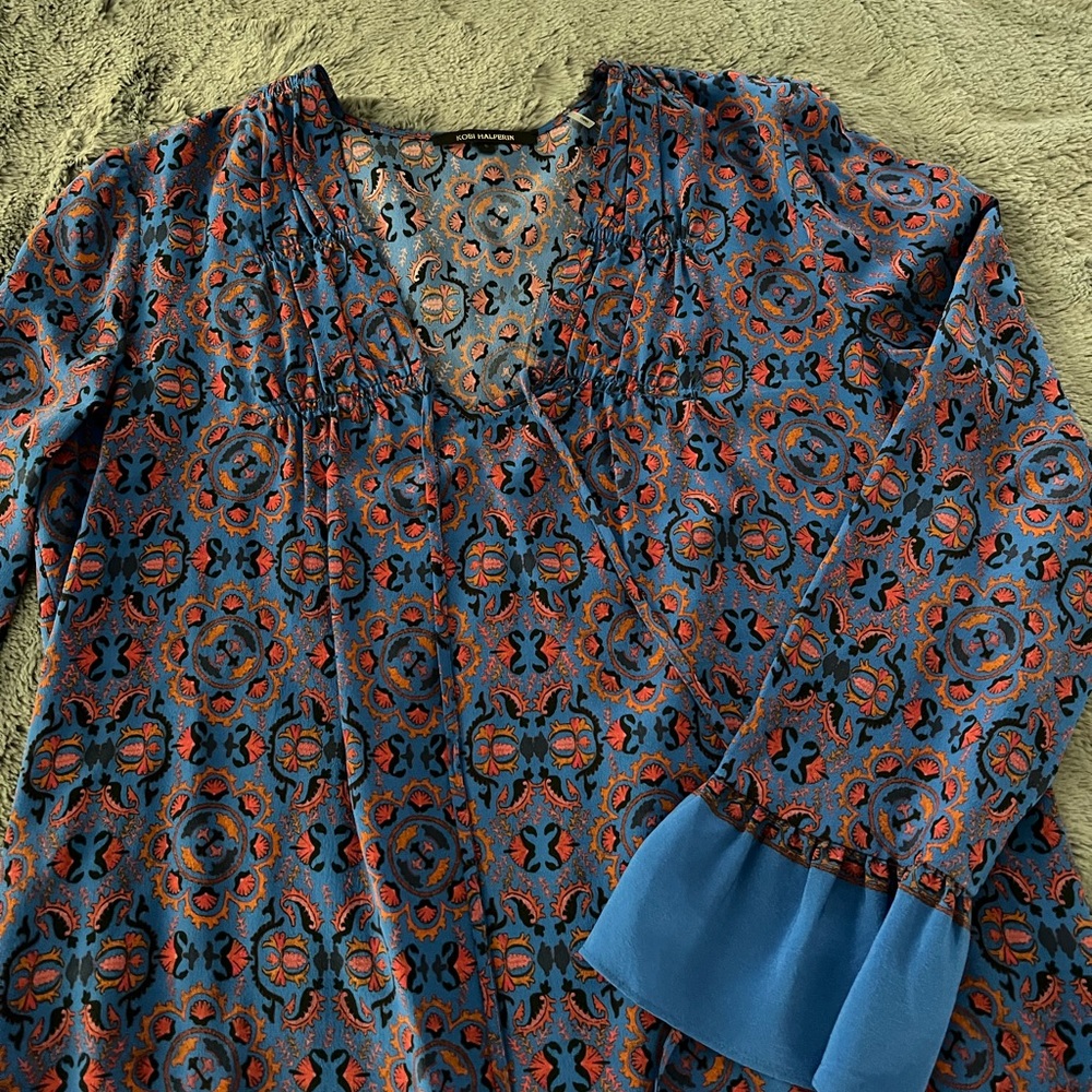 Blue with pink, orange and black pattern silk blouse with bell sleeves.